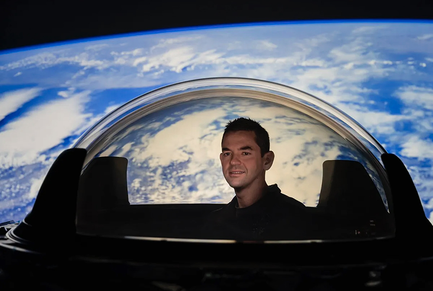 Billionaire Jared Isaacman, who bought SpaceX's first private spaceflight, checks the view from the cupola window. 